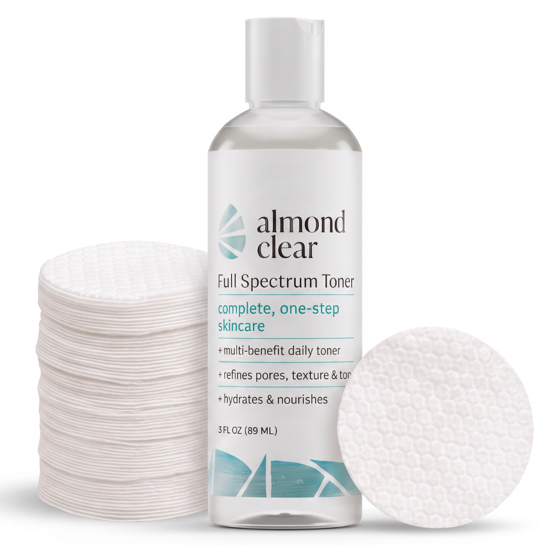 Almond Clear Full Spectrum Toner bottle with a white cap, shown with a stack of cotton pads on the left and a single round cotton pad on the right against a white background.